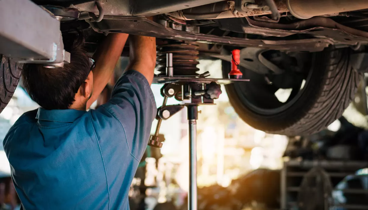 A mechanic working on a vehicle.
