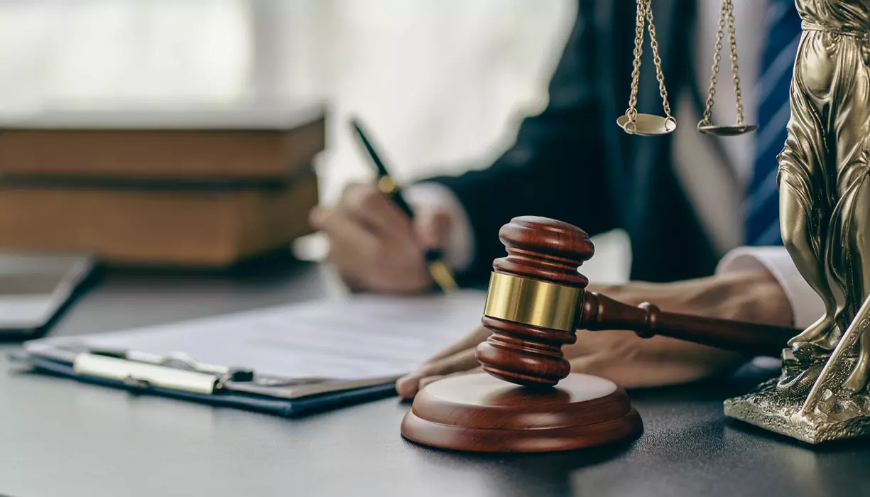 A judge writing on a document.