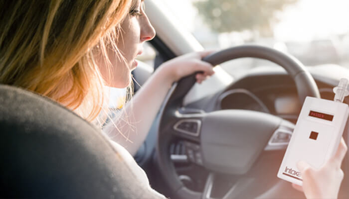 Woman holding device while driving