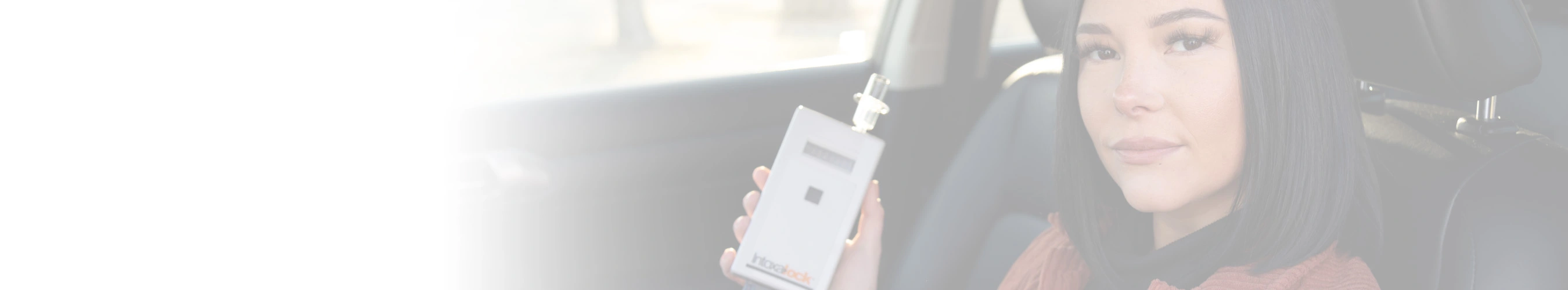 woman sitting in car with device